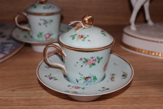 A pair of Paris porcelain chocolate cups, covers and stands, a Samson mug and an ironstone strainer